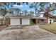 Brick home with two-car garage and driveway at 4646 W Longfellow Ave, Tampa, FL 33629