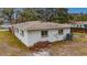 Single story home's side view, showcasing the exterior condition and landscaping at 4646 W Longfellow Ave, Tampa, FL 33629