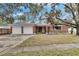 Brick house with two-car garage and mature trees at 4646 W Longfellow Ave, Tampa, FL 33629