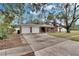 Brick house with two-car garage and driveway at 4646 W Longfellow Ave, Tampa, FL 33629