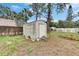 White shed in the backyard provides extra storage at 4646 W Longfellow Ave, Tampa, FL 33629