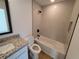 Bathroom with granite countertop, white vanity, and bathtub shower combo at 5402 Ojus St, North Port, FL 34286