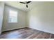 Well-lit bedroom featuring wood-look floors and a window at 5701 N 20Th St, Tampa, FL 33610