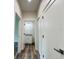 Hallway with wood-look floors and access to bathroom at 5701 N 20Th St, Tampa, FL 33610