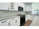 Modern kitchen with white cabinets, marble backsplash, and island at 5701 N 20Th St, Tampa, FL 33610