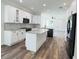 Modern kitchen with white cabinets, marble backsplash, and island at 5701 N 20Th St, Tampa, FL 33610