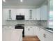 White cabinets, marble backsplash, and stainless steel appliances at 5701 N 20Th St, Tampa, FL 33610