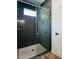 Large walk-in shower with pebble floor and dark tile at 5701 N 20Th St, Tampa, FL 33610