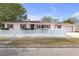 Charming mid-century home with white picket fence and red accents at 600 30Th N St, St Petersburg, FL 33713