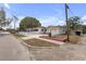 Single story home with white picket fence, pink planter, and attached garage at 600 30Th N St, St Petersburg, FL 33713