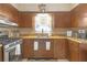 Kitchen with wood cabinets, a window, and stainless steel appliances at 600 30Th N St, St Petersburg, FL 33713