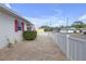 Side yard with brick pavers and white fence at 600 30Th N St, St Petersburg, FL 33713