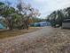 Mobile home on a large lot with a gravel driveway at 6274 Boatwrite Rd, Spring Hill, FL 34609