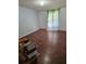 Spacious bedroom with wood-look floors and large window at 6274 Boatwrite Rd, Spring Hill, FL 34609