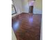 Second bedroom with wood flooring and large mirror at 6274 Boatwrite Rd, Spring Hill, FL 34609