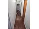 Long hallway with wood flooring and access to bedrooms at 6274 Boatwrite Rd, Spring Hill, FL 34609