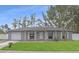 Gray house with white shutters, attached garage, and manicured lawn at 6543 Spanish Moss Cir, Tampa, FL 33625