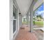 Covered walkway with terracotta tile flooring and gray columns at 6543 Spanish Moss Cir, Tampa, FL 33625