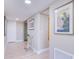 Bright hallway with light flooring, framed art, and a small accent table at 7600 Sun Island S Dr # 804, South Pasadena, FL 33707