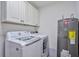 Bright laundry room with washer, dryer, and cabinets at 7600 Sun Island S Dr # 804, South Pasadena, FL 33707