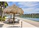 Relaxing waterfront patio area with thatched umbrellas at 7600 Sun Island S Dr # 804, South Pasadena, FL 33707