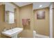 Small bathroom with pedestal sink and toilet at 800 S Gulfview Blvd # 101, Clearwater Beach, FL 33767