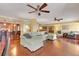 Living room with hardwood floors, sectional sofa, and ceiling fan at 800 S Gulfview Blvd # 101, Clearwater Beach, FL 33767