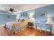 Main bedroom with light blue walls and hardwood floors at 800 S Gulfview Blvd # 101, Clearwater Beach, FL 33767