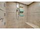 Large walk-in shower with tile surround and bench at 800 S Gulfview Blvd # 101, Clearwater Beach, FL 33767