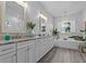 Elegant bathroom with double vanity, soaking tub, and white tile at 821 Forest Glen Ct, Palm Harbor, FL 34683