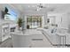 Living room with sectional sofa, fireplace, and pool view at 821 Forest Glen Ct, Palm Harbor, FL 34683