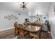 Dining area with wood table and chairs, adjacent to the living room at 8703 Bardmoor Blvd # 106, Seminole, FL 33777