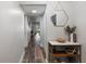 Bright hallway with wood-look floors and a stylish entry table at 8703 Bardmoor Blvd # 106, Seminole, FL 33777