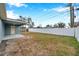 Home exterior and backyard with a white fence at 9100 52Nd N Way, Pinellas Park, FL 33782