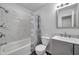 Updated bathroom with gray vanity, white toilet, and marble-tiled shower/tub combo at 9100 52Nd N Way, Pinellas Park, FL 33782