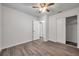 Bedroom with ceiling fan, double door closet, and wood-look floors at 9100 52Nd N Way, Pinellas Park, FL 33782