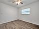 Simple bedroom with ceiling fan and wood-look floors at 9100 52Nd N Way, Pinellas Park, FL 33782