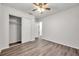 Bedroom with ceiling fan, closet, and wood-look floors at 9100 52Nd N Way, Pinellas Park, FL 33782