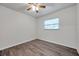 Simple bedroom with ceiling fan, window, and wood-look floors at 9100 52Nd N Way, Pinellas Park, FL 33782