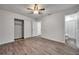 Well-lit bedroom with wood-look floors, ceiling fan and ensuite bathroom at 9100 52Nd N Way, Pinellas Park, FL 33782