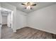 Bedroom with ceiling fan, double door closet, and wood-look floors at 9100 52Nd N Way, Pinellas Park, FL 33782