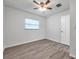 Bedroom with ceiling fan, window, and wood-look floors at 9100 52Nd N Way, Pinellas Park, FL 33782