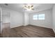 Spacious bedroom with wood-look floors, ceiling fan and access to another room at 9100 52Nd N Way, Pinellas Park, FL 33782