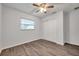 Bedroom with ceiling fan, closet, and wood-look floors at 9100 52Nd N Way, Pinellas Park, FL 33782