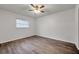 Bright bedroom featuring wood-look floors and a ceiling fan at 9100 52Nd N Way, Pinellas Park, FL 33782