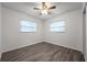 Bedroom with ceiling fan, dual windows, and wood-look floors at 9100 52Nd N Way, Pinellas Park, FL 33782