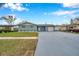 Newly painted light blue house with a 1-car garage and manicured lawn at 9100 52Nd N Way, Pinellas Park, FL 33782