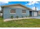 Light blue house with stone accents and nicely landscaped front yard at 9100 52Nd N Way, Pinellas Park, FL 33782