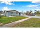 Ranch style home with a wide driveway and nicely landscaped lawn at 9100 52Nd N Way, Pinellas Park, FL 33782