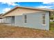 Rear view of the house showing a light blue exterior at 9100 52Nd N Way, Pinellas Park, FL 33782